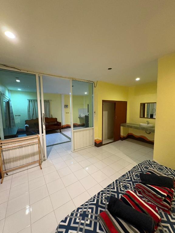 a large room with a bed and a bathroom at Jano House in Ban Mae Nam