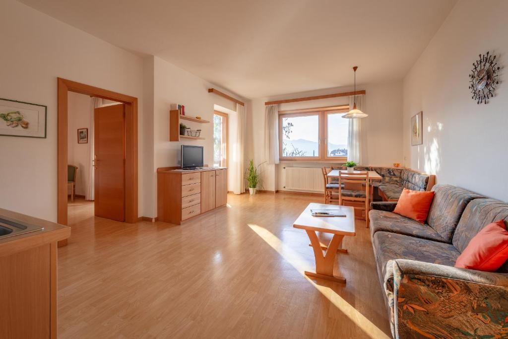 a living room with a couch and a table at Apartments Haus Weinberg in Caldaro