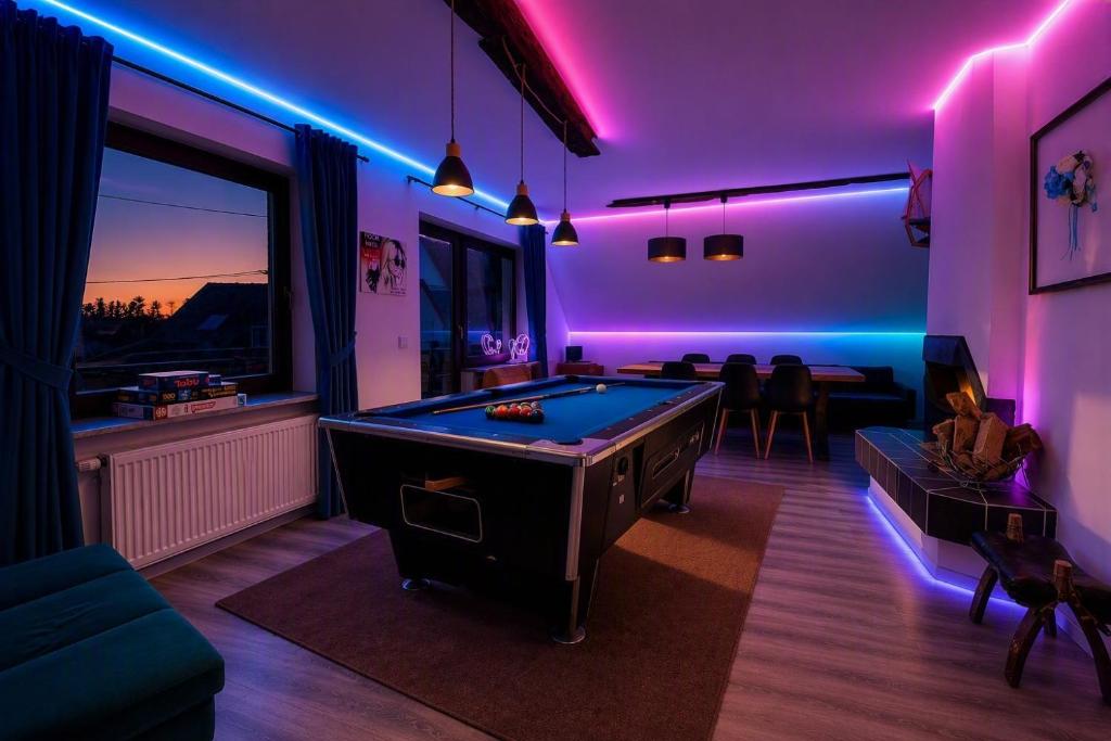 a room with a pool table and purple lights at Whirlpool Kamin Sauna Herthasee in Eppenrod