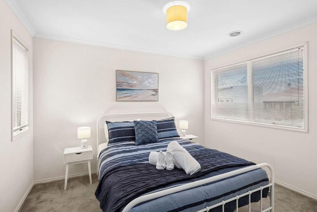 a bedroom with a large bed with two pillows at Beach Living Bliss in Torquay