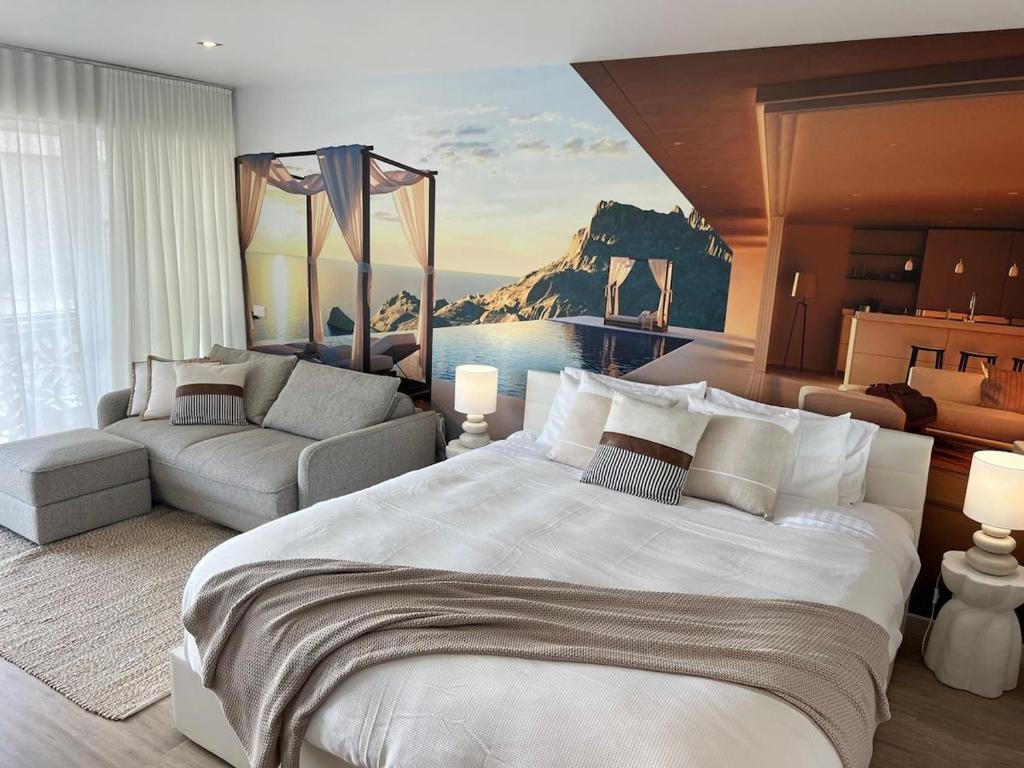 a bedroom with a large bed and a couch at Bay View Motel - Sunrise in Lorne