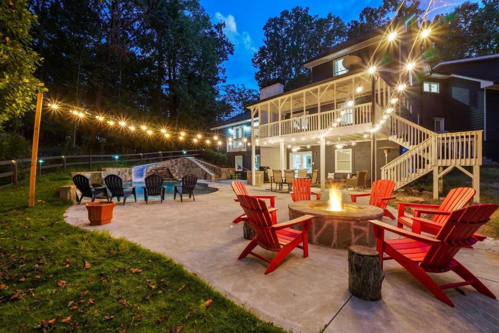 a patio with chairs and a table and a house at Georgia Lakeside Getaway with Private Pool in Flowery Branch