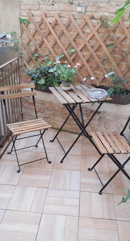 a table and two chairs on a patio at Trivia Rent in Reggio di Calabria