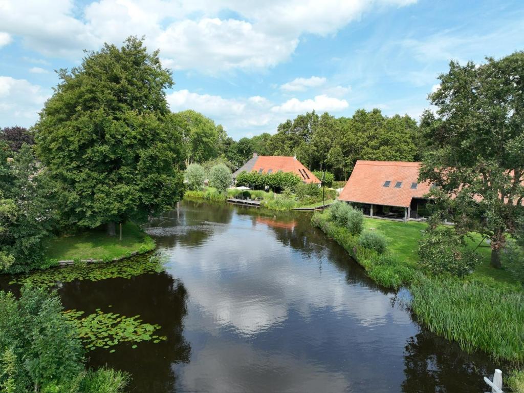 a river with buildings in the background and a river with trees at Uitgerust voor Zaken in Heerenveen