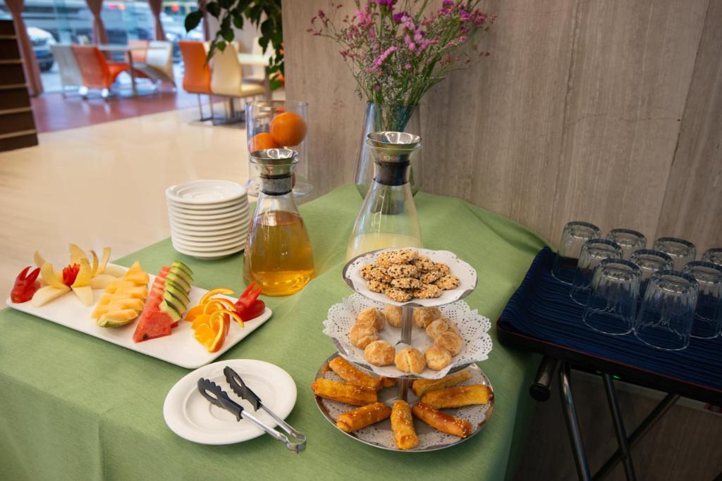 a table with plates of food on a green table at Holiday Inn Express Chengdu Wuhou by IHG-Wuhou Temple and Jinli in Chengdu