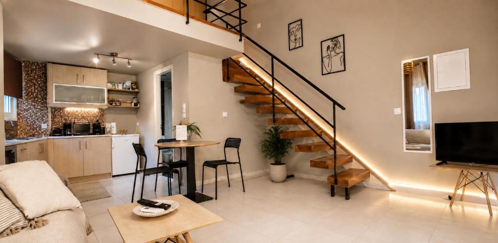 a living room and kitchen with a spiral staircase at Deodonum Luxury Apartments in Heraklio