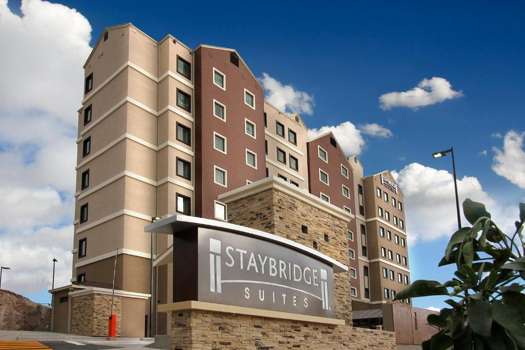 a tall building with a sign in front of it at Staybridge Suites Chihuahua by IHG in Chihuahua