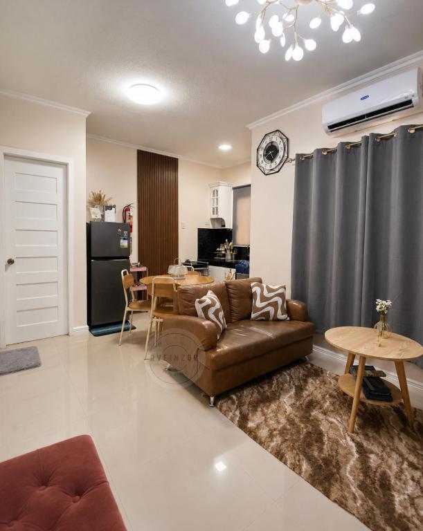 a living room with a couch and a table at Cozy Home in Dipolog by Aveinz in Dipolog