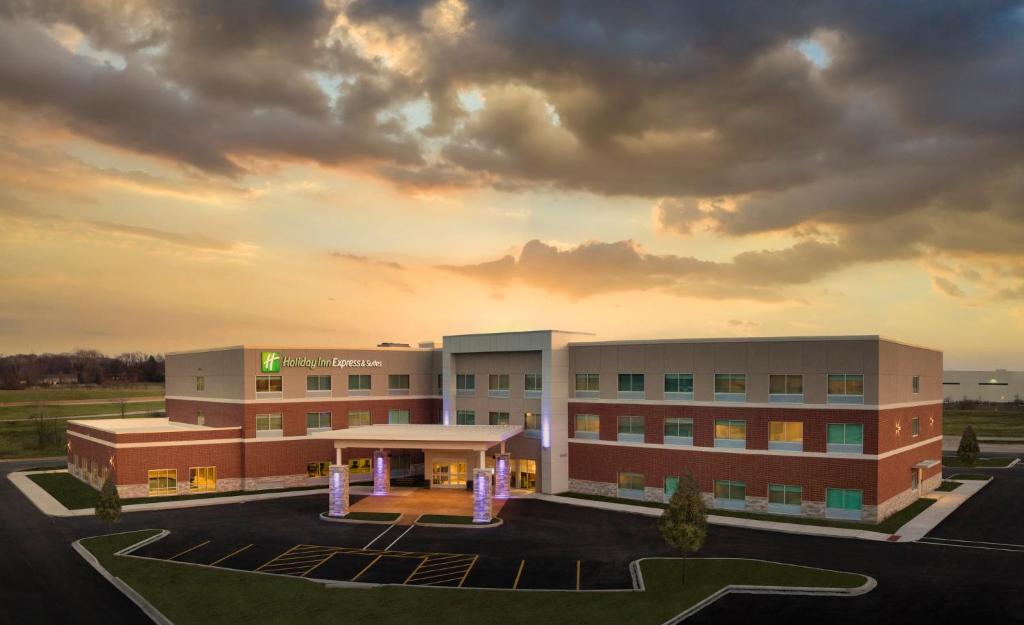 a hospital building with a sunset in the background at Holiday Inn Express & Suites - Lockport by IHG in Lockport