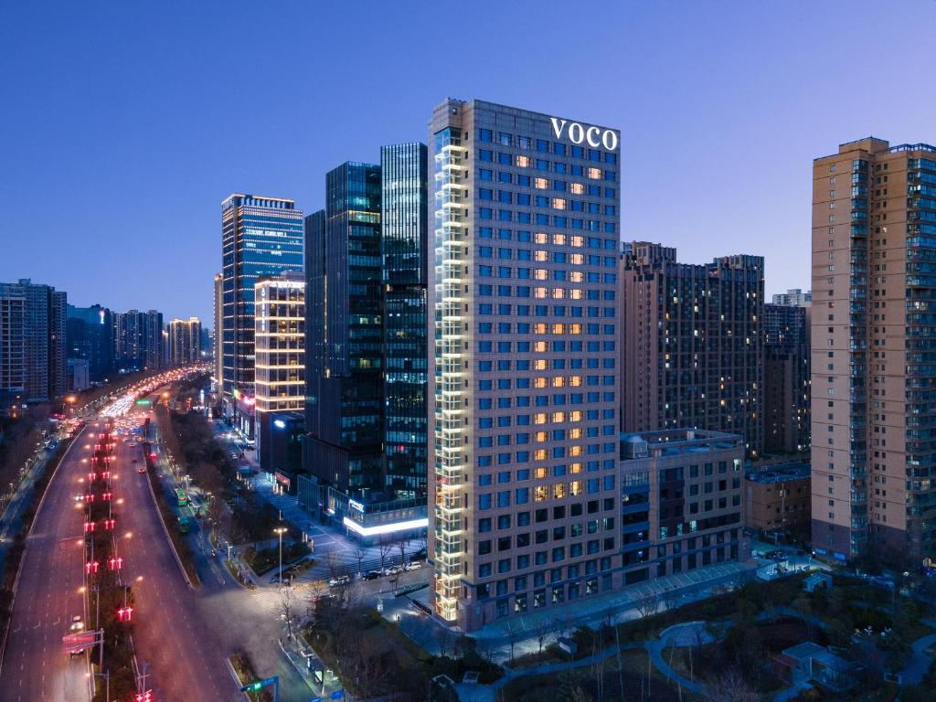 a view of a large city at night with traffic at voco Xian ETDZ by IHG in Xi'an