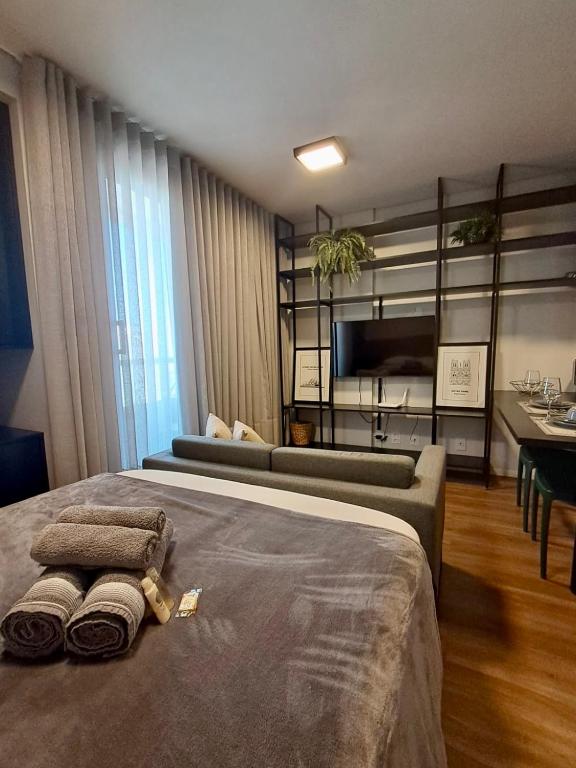 a bedroom with a bed with two towels on it at Studio Cuiabá NOVO - Frente ao Shopping Estação in Cuiabá