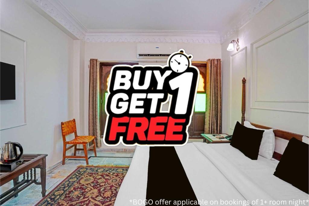 a bedroom with a bed with a buy get free sign at Palette Hotel and Resorts Jodhpur Airport Formerly Royale Plazo in Jodhpur
