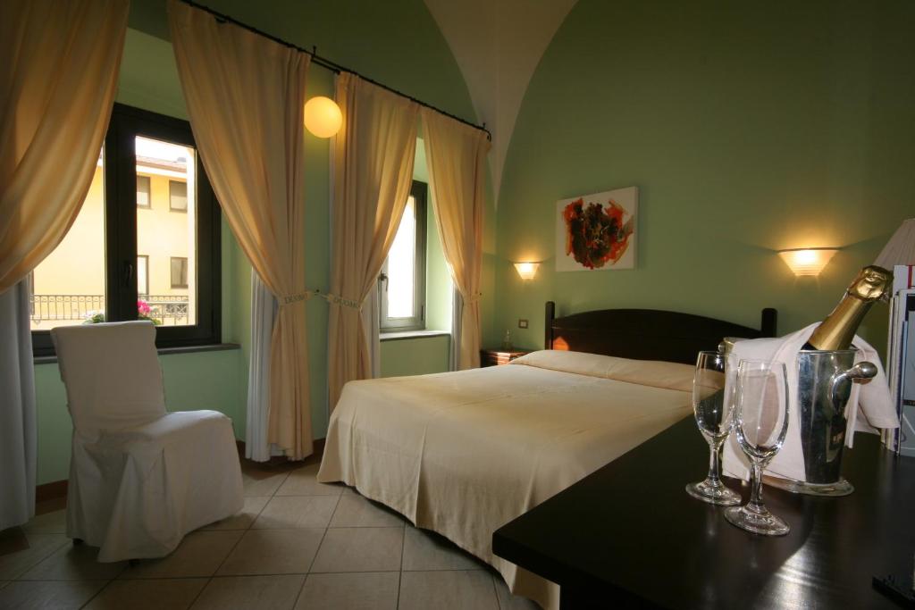 Postel nebo postele na pokoji v ubytování Hotel Il Duomo PHG