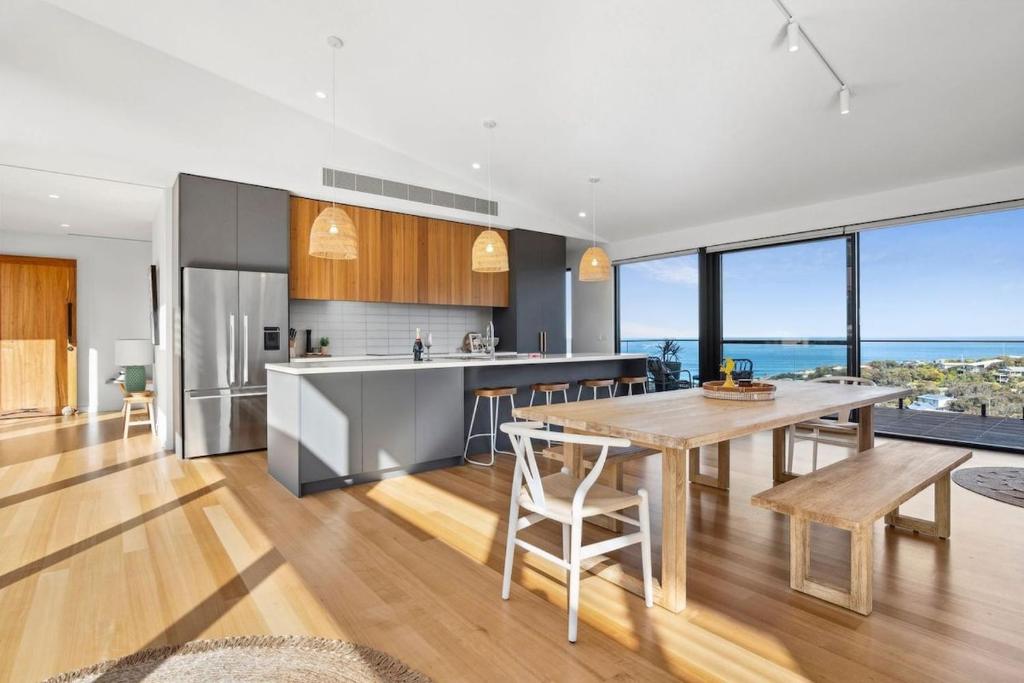 a kitchen and dining room with a table and chairs at Hakea Ridge in Aireys Inlet