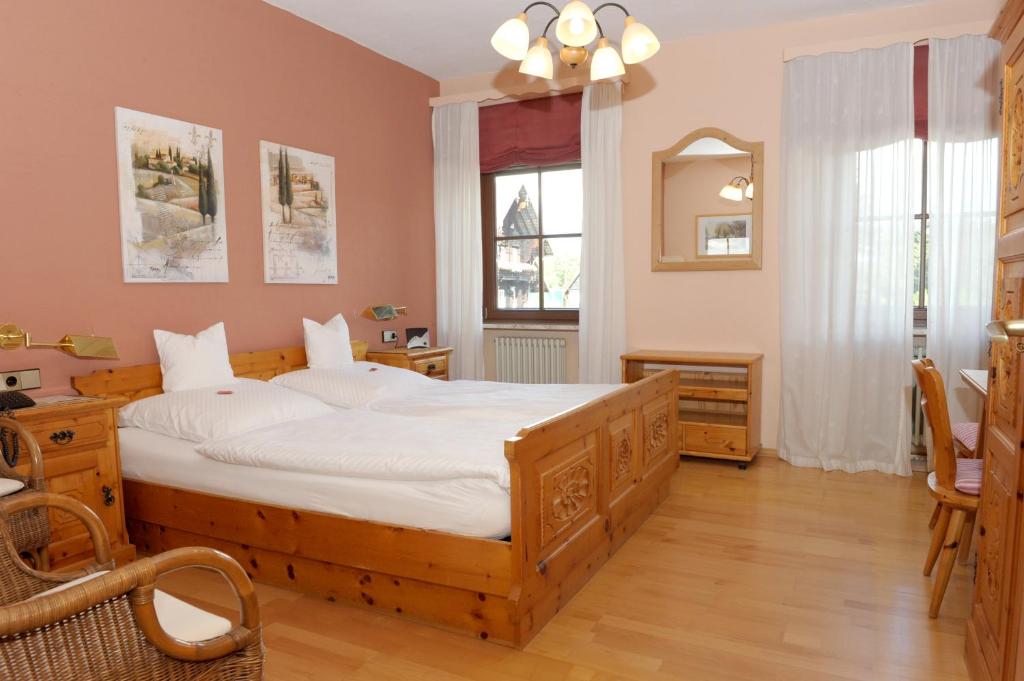 a bedroom with a large bed and a window at Hotel Sarbacher in Gernsbach