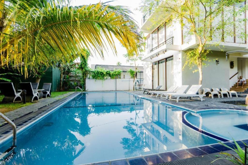 a swimming pool in front of a house at White House 101 in Galle