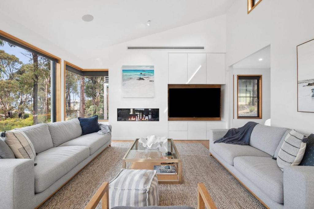 a living room with two couches and a tv at Bimbadeen Bliss in Aireys Inlet