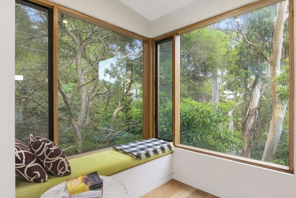 a window seat in a room with a view of trees at Clovelly - BYO Linen in Lorne