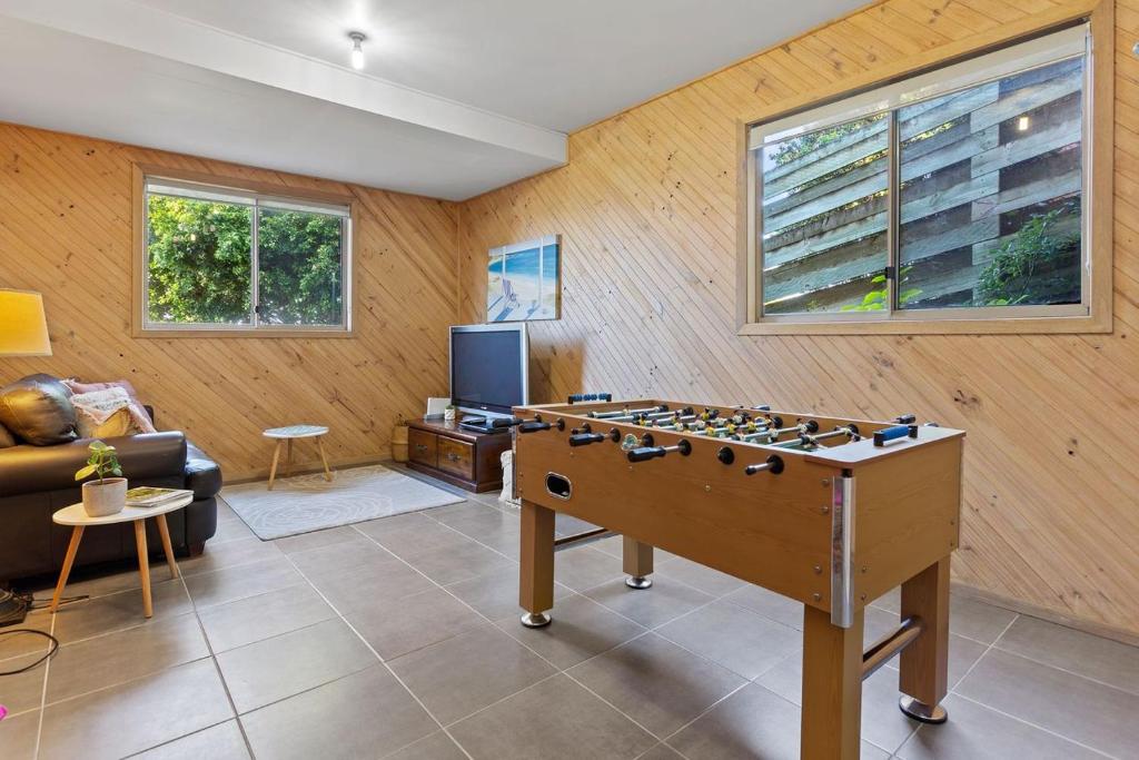 a living room with a foosball table at Otway Views in Apollo Bay