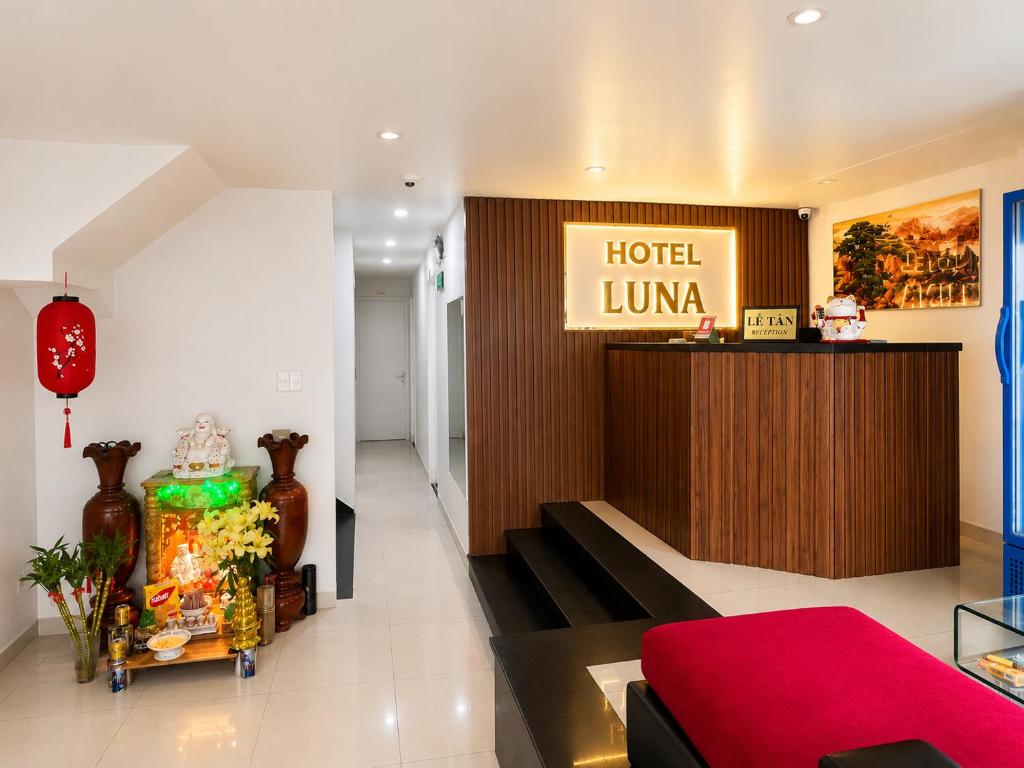 a hotel lobby with a hotel union sign on the wall at LUNA Hotel in Ho Chi Minh City