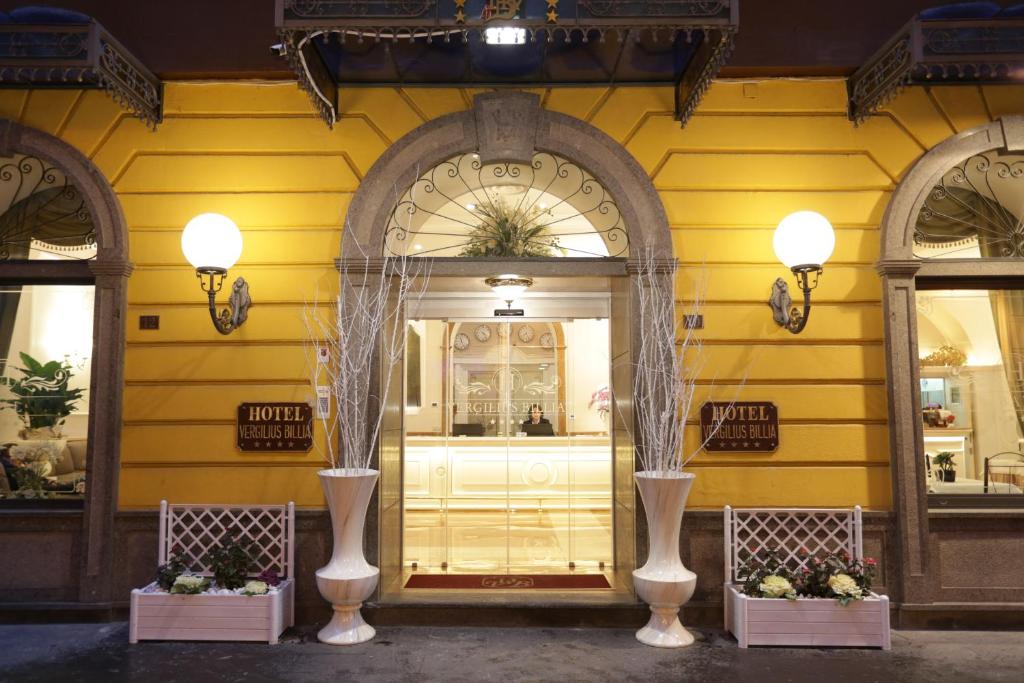 a store front with three windows and a yellow wall at Hotel Vergilius Billia in Naples