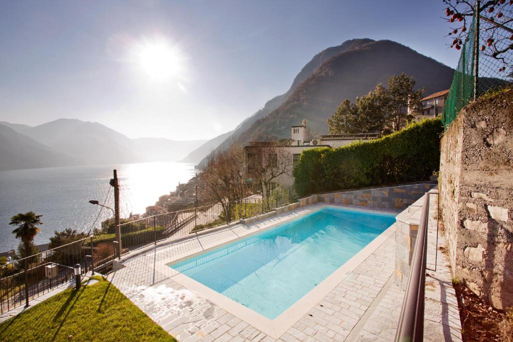 a swimming pool with a view of a mountain at Argegno Pool apartment by Italian Apartments in Argegno