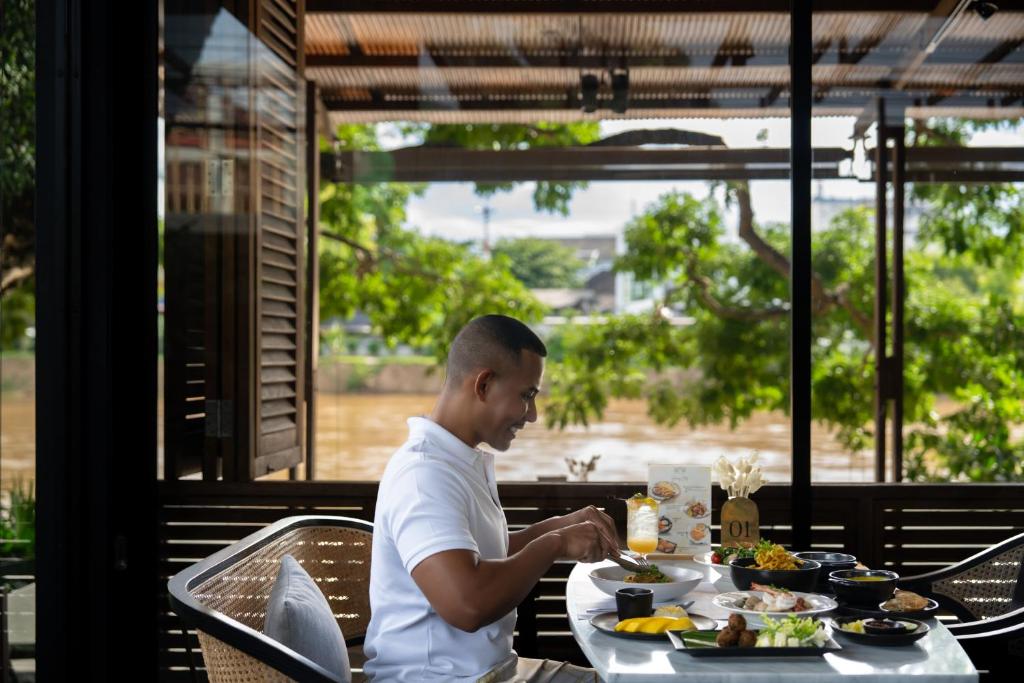 A breakfast table beside a bright garden-facing window.