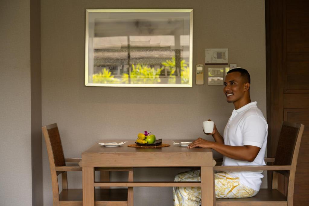 A small dining or work table set inside a guest room.