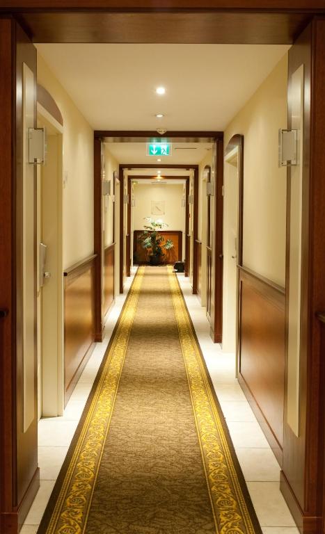 a hallway of a hotel with a long aisle at Best Western Plus Grand Hotel Victor Hugo in Luxembourg