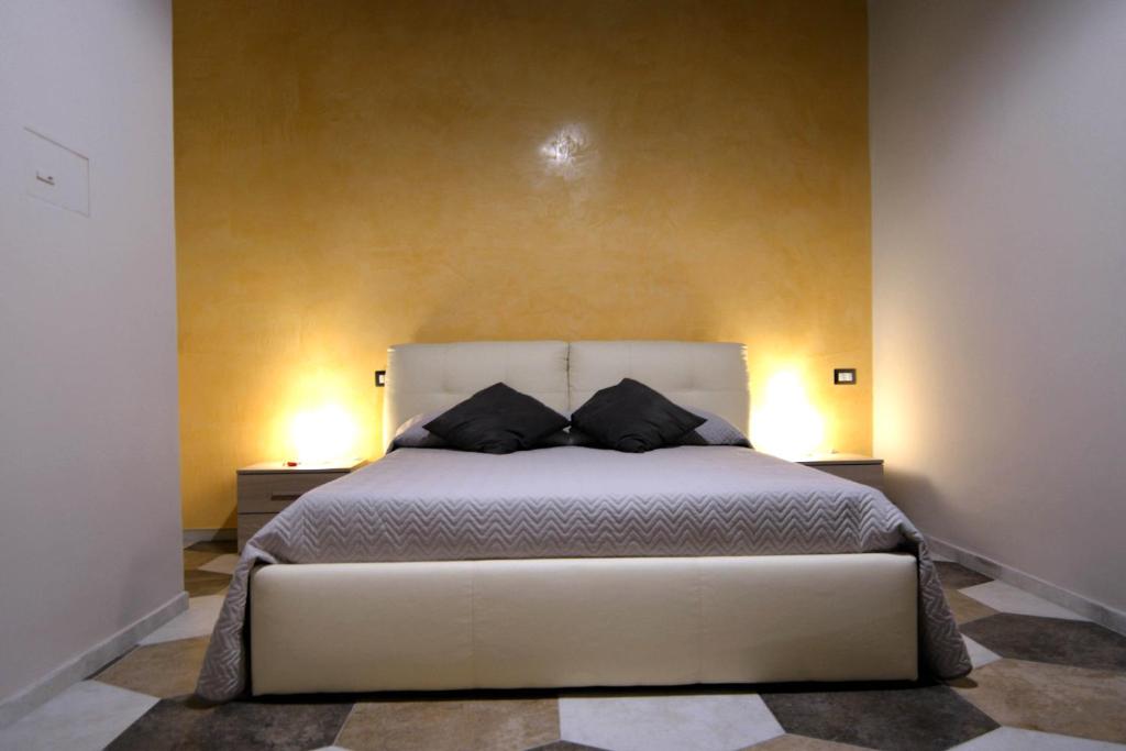 a bedroom with a bed with two pillows on it at Residence Stendhal Guest House in Civitavecchia