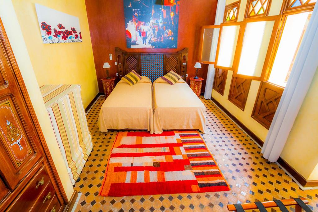 Postel nebo postele na pokoji v ubytování Riad Assilah