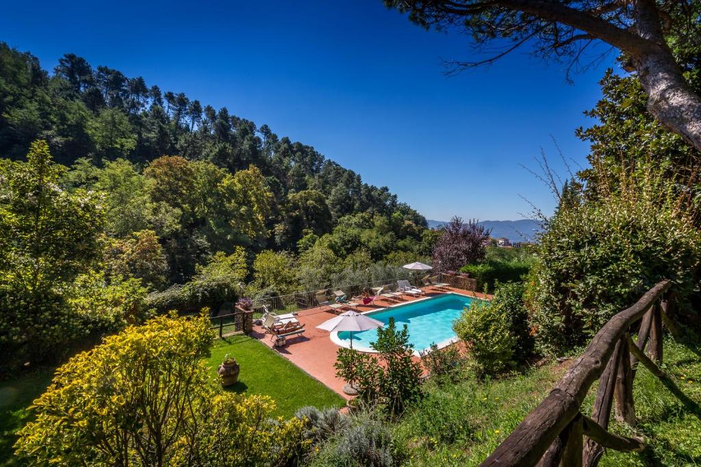 a swimming pool in a garden with a view at Podere Casalino in Reggello
