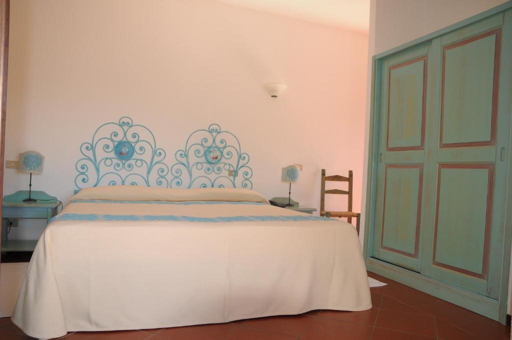 Postel nebo postele na pokoji v ubytování Hotel Capriccioli