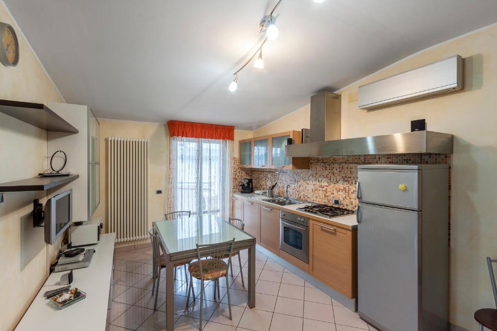 a kitchen with a table and a counter top at Palazzo Giallo in Alba Adriatica