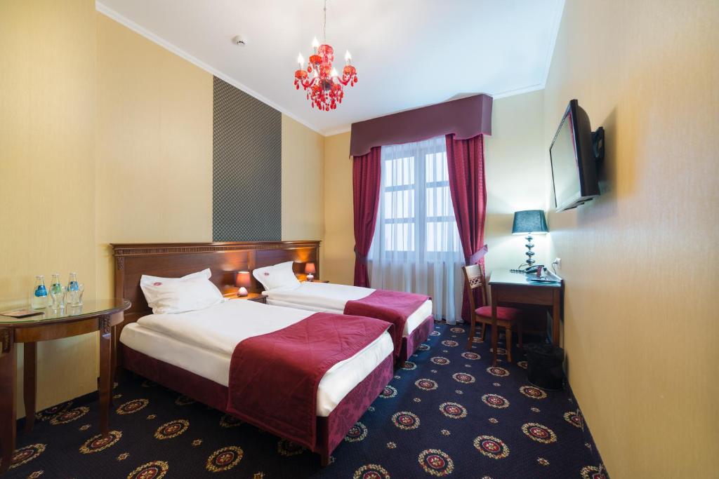 Posteľ alebo postele v izbe v ubytovaní Hotel Jarosław
