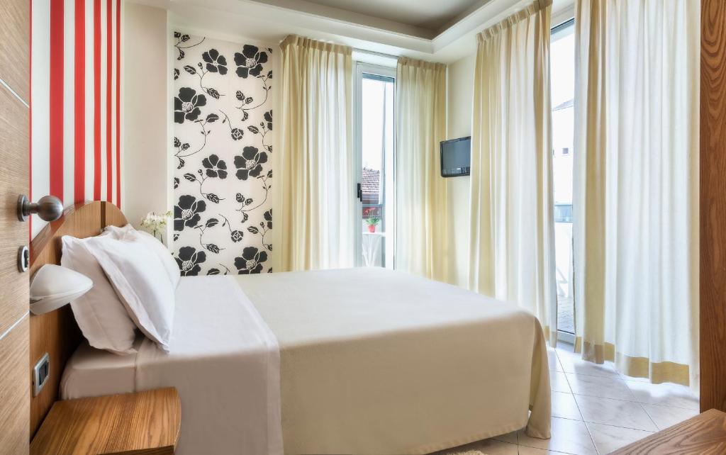 Postel nebo postele na pokoji v ubytování ACasaMia WelcHome Hotel