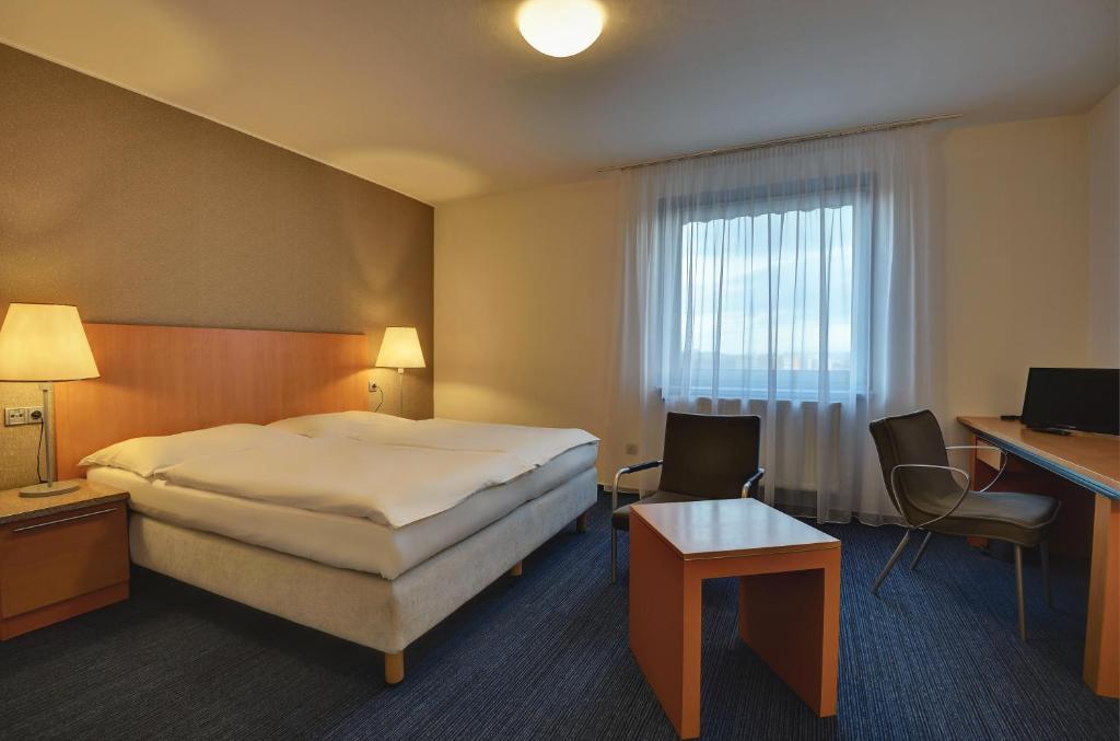 Łóżko lub łóżka w pokoju w obiekcie Hotel Henrietta
