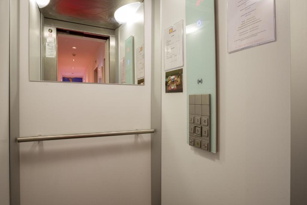 a door in a room with a mirror at Hotel Ambassador in Solothurn