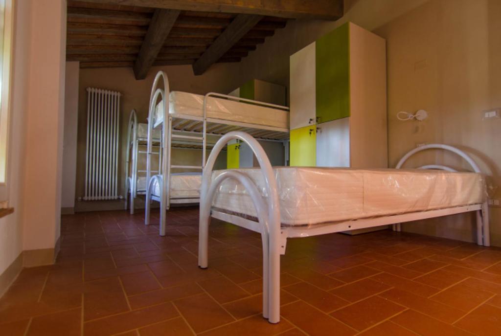 Posteľ alebo postele v izbe v ubytovaní Ostello San Miniato