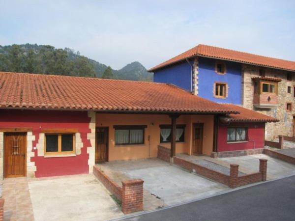 een huis met een rood en blauw bij Apartamentos Puente Viesgo Anjana in Puente Viesgo