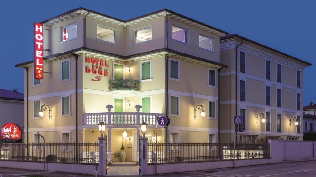 a large building with a sign in front of it at Hotel Doge in Vicenza