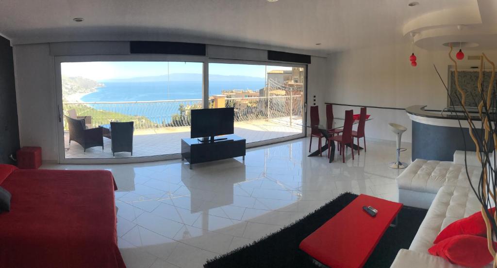 a living room with a view of the ocean at Prestige Loft Taormina in Taormina
