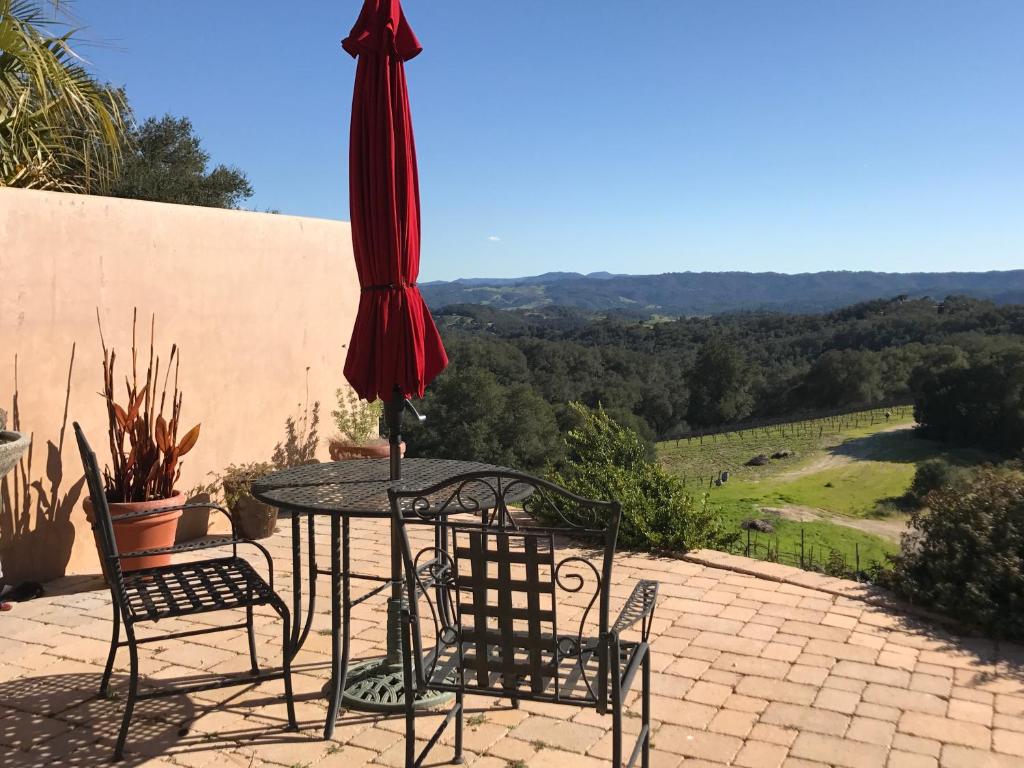 a table and chairs and an umbrella on a patio at Dunning Vineyards Guest Villa in Paso Robles
