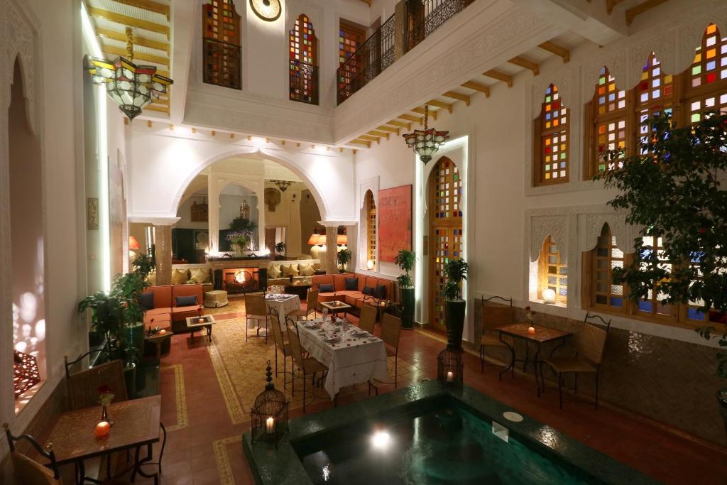 een lobby met een zwembad in het midden van een gebouw bij Riad Andallaspa in Marrakesh