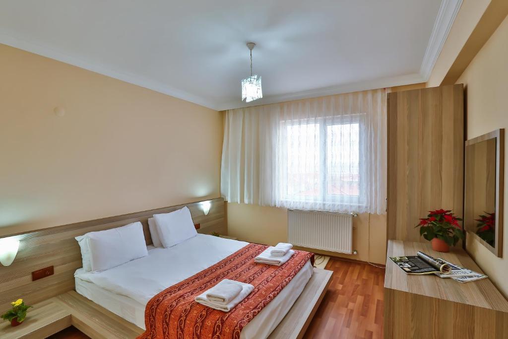 a bedroom with a bed with two towels on it at Afyon Can Termal Apart in Afyon