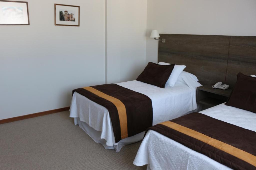 Postel nebo postele na pokoji v ubytování Conrado Hotel Osorno