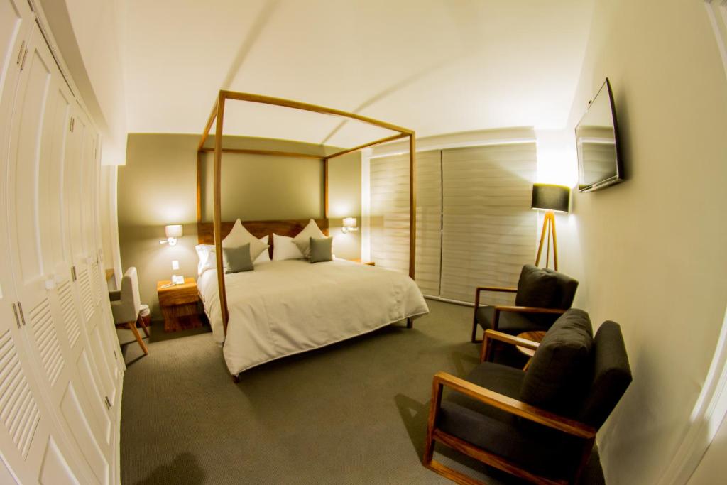 Postel nebo postele na pokoji v ubytování Hotel Boutique Abad