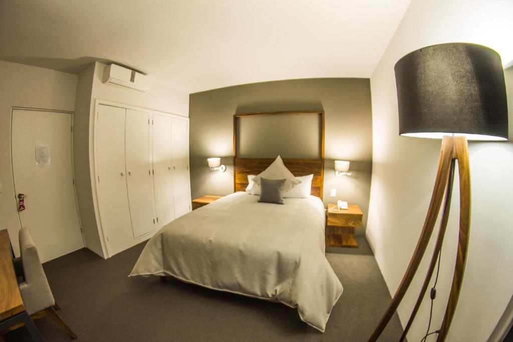 Postel nebo postele na pokoji v ubytování Hotel Boutique Abad