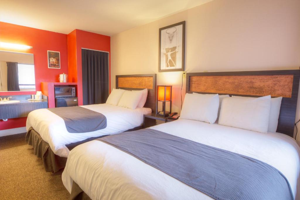 a hotel room with two beds and a bathroom at Hotel Ruby in Spokane
