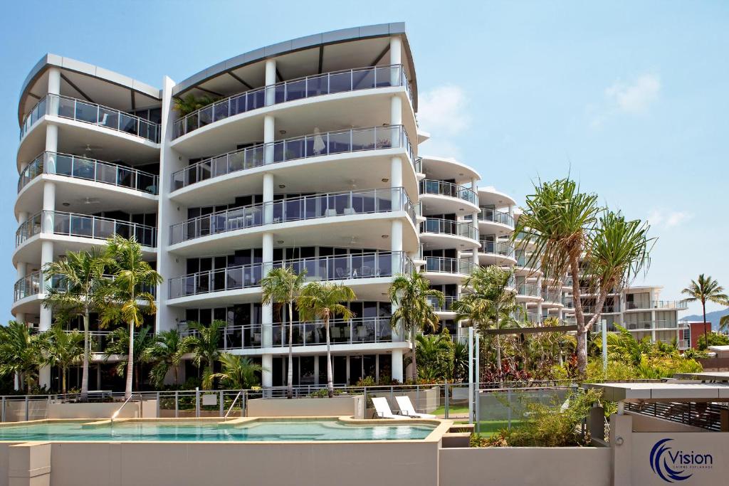a large building with a large window overlooking the ocean at Vision Apartments in Cairns